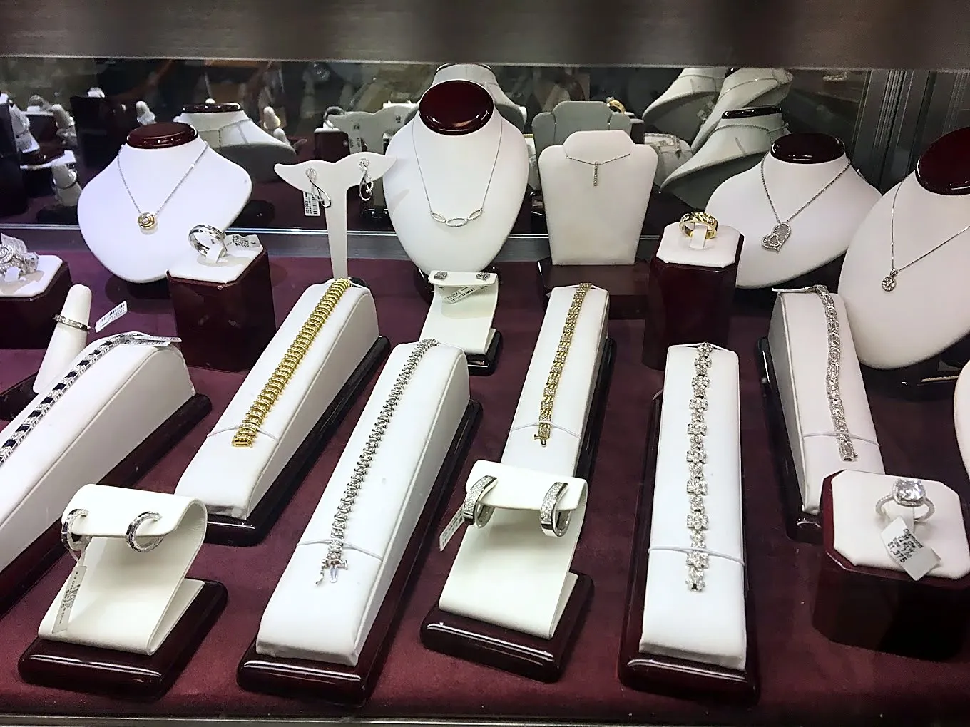 Bracelets laid out in the case, pendants behind