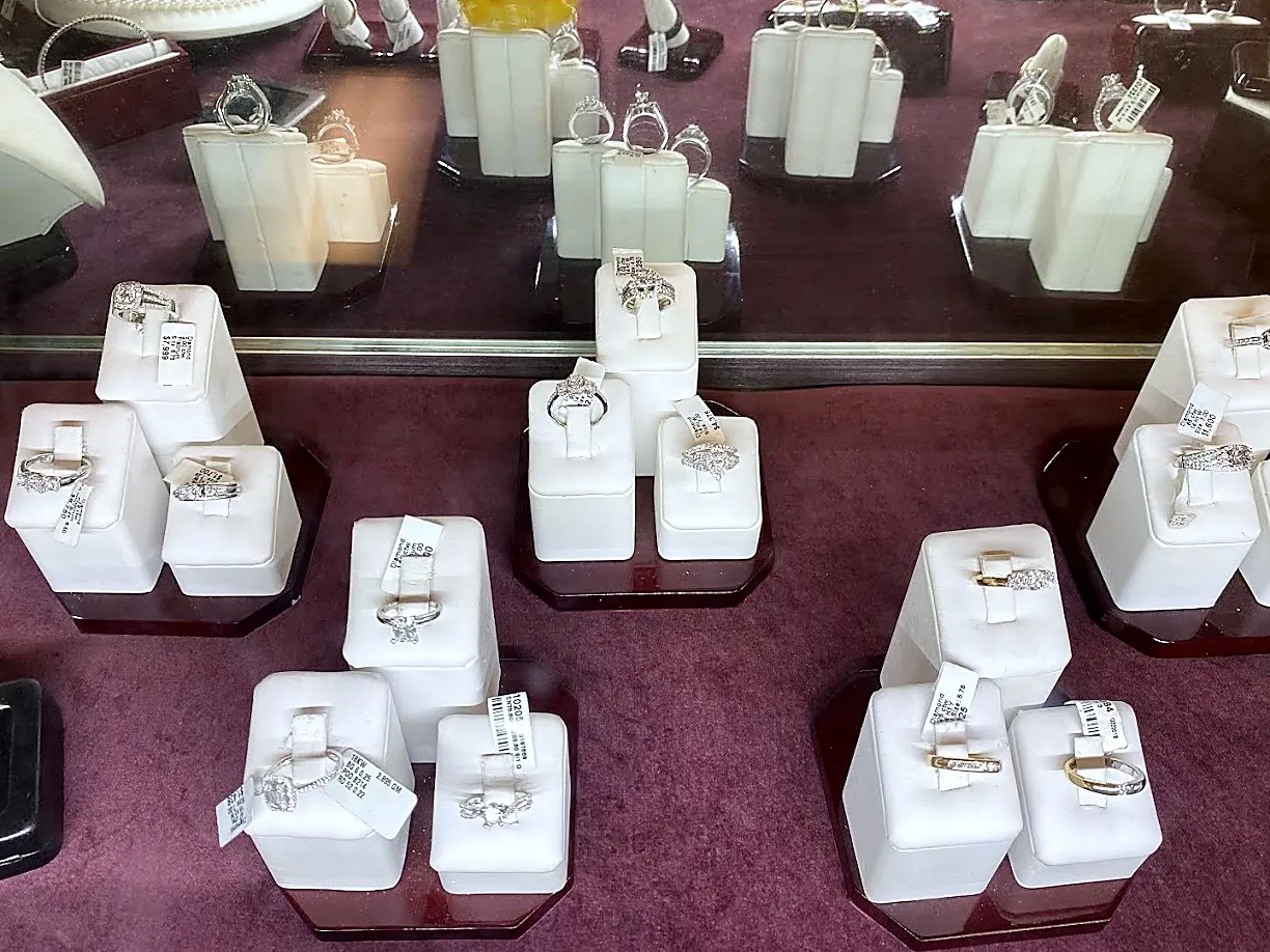 Rings on white stands in the case