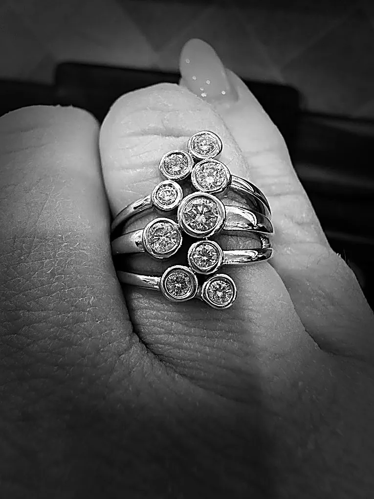A ring of bezel-set stones, worn