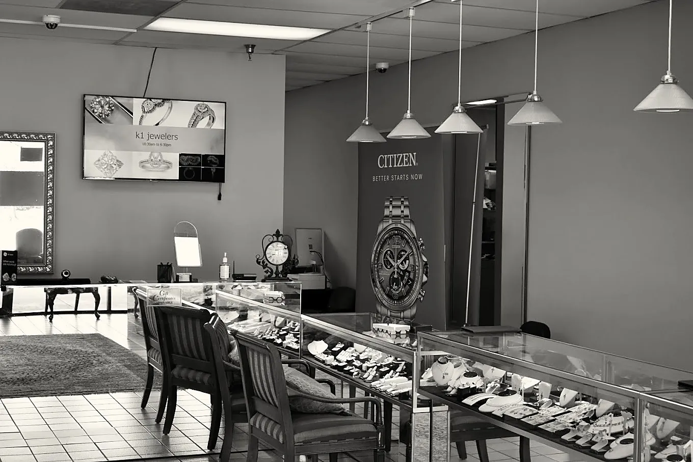 Inside K1 Jewelers. The cases, the counter, and the shop’s name on the screen.